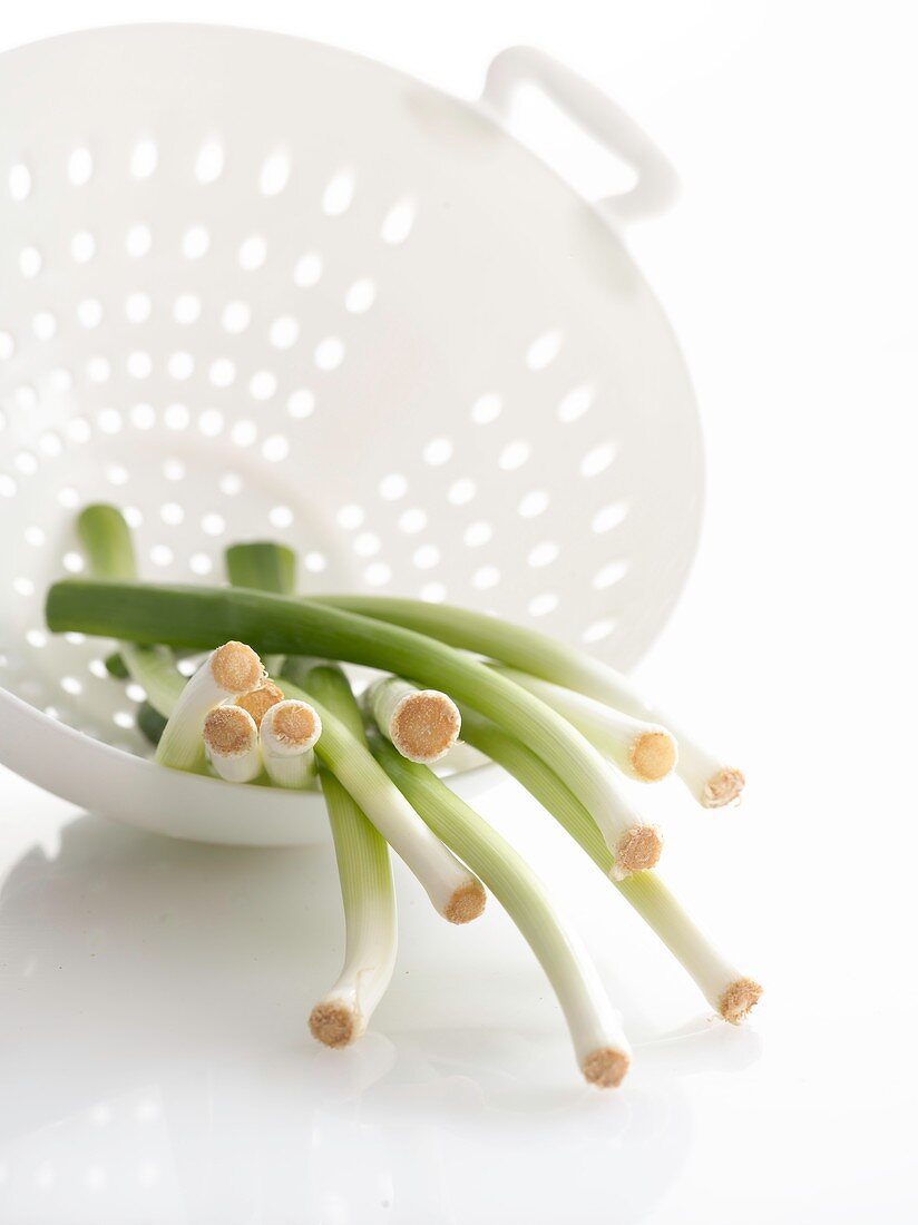 Spring onions in a colander