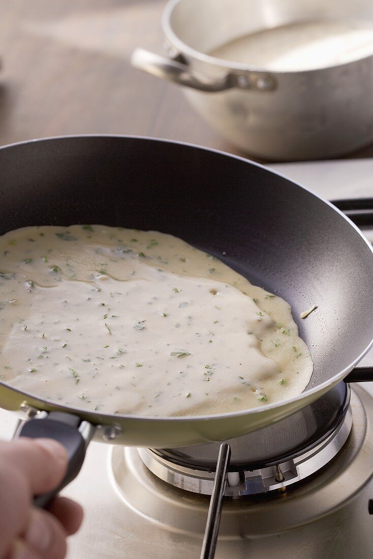 A herb pancake being fried