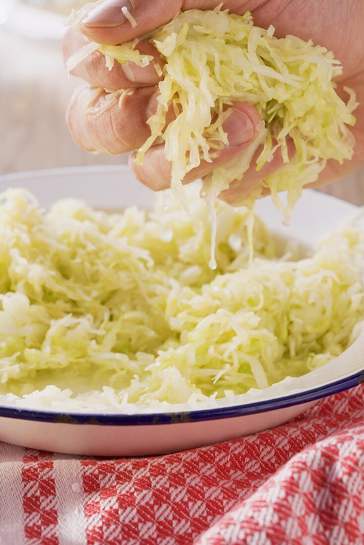 White cabbage being kneaded