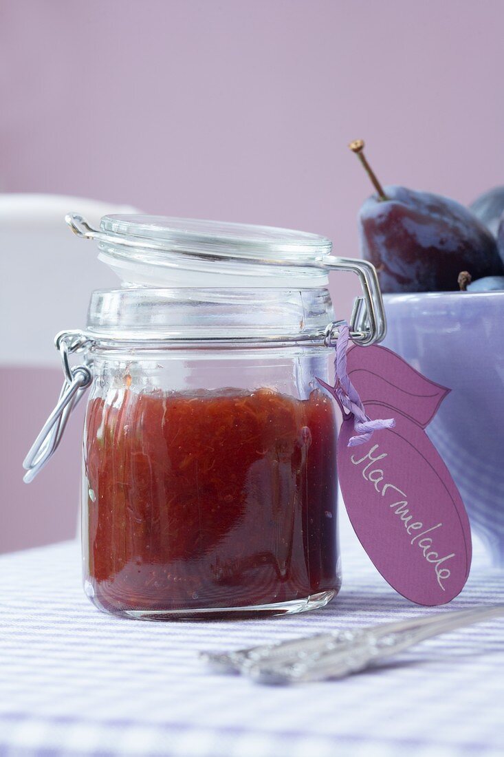 Plum jam in a preserving jar with a label