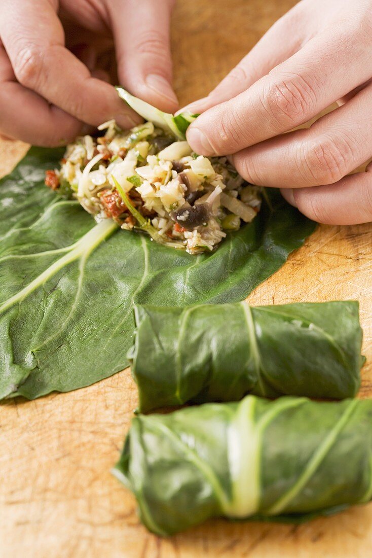 Chard roulade with an aubergine filling being prepared