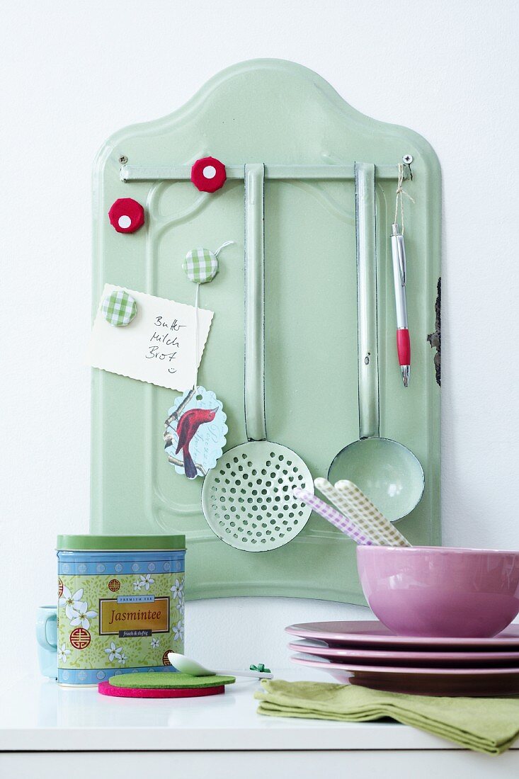 Enamel wall holder with magnets and kitchen utensils