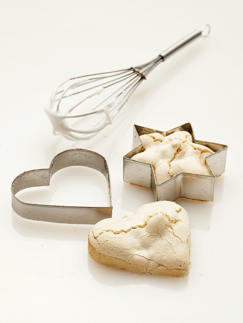 A whisk and cutters with meringue