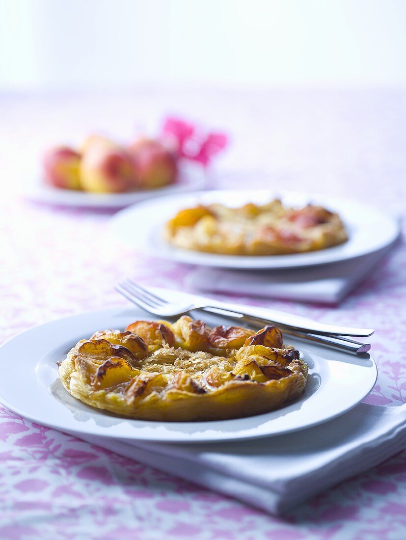 Individual peach tarts on plates