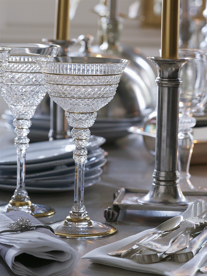 Glasses, candles and cutlery in silver and gold