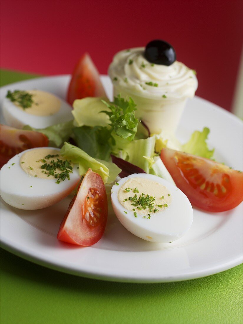 Hard-boiled eggs with tomatoes and mayonnaise