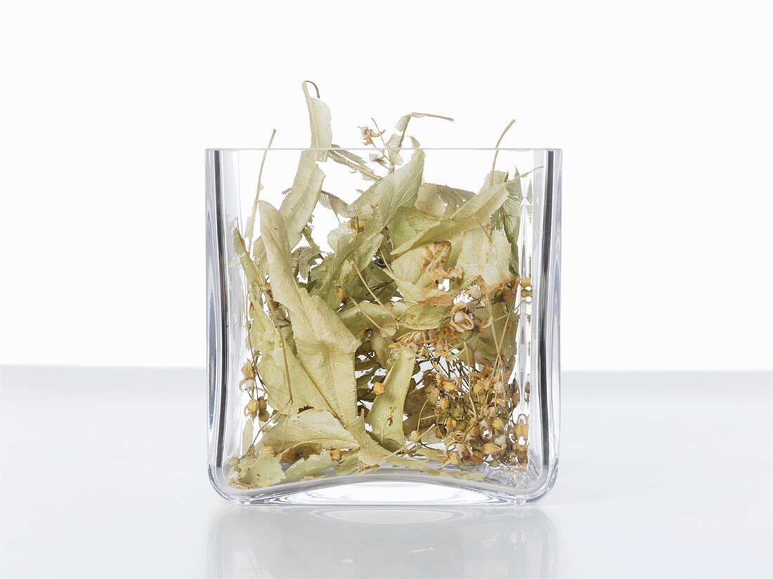 Dried lime flowers in a glass container