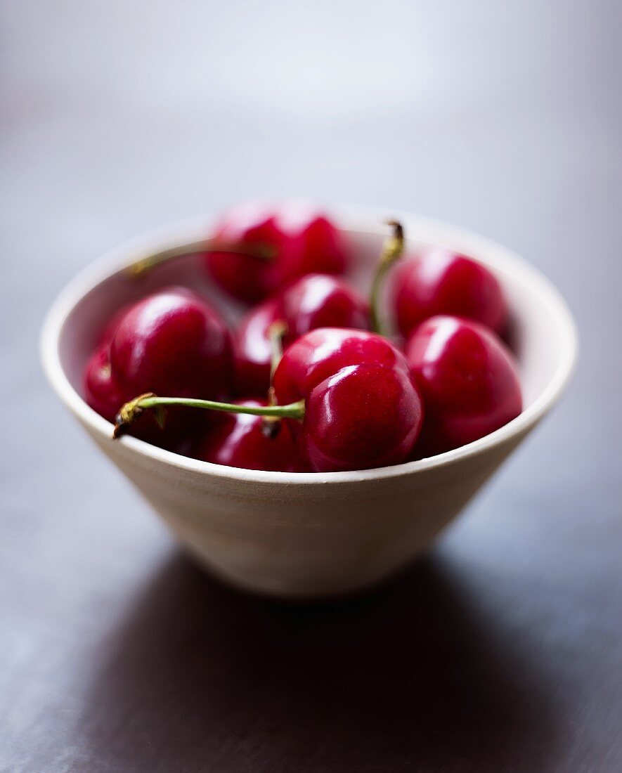 Several cherries in ceramic bowl