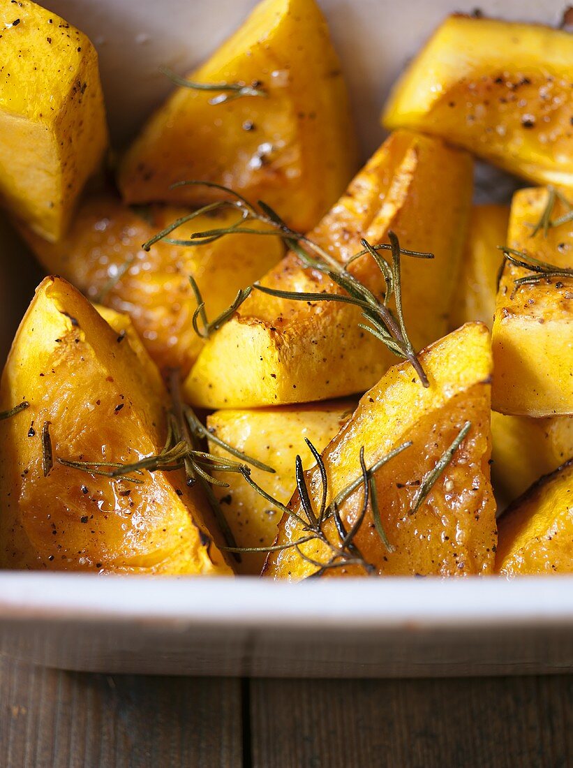 Oven-baked pumpkin pieces with rosemary