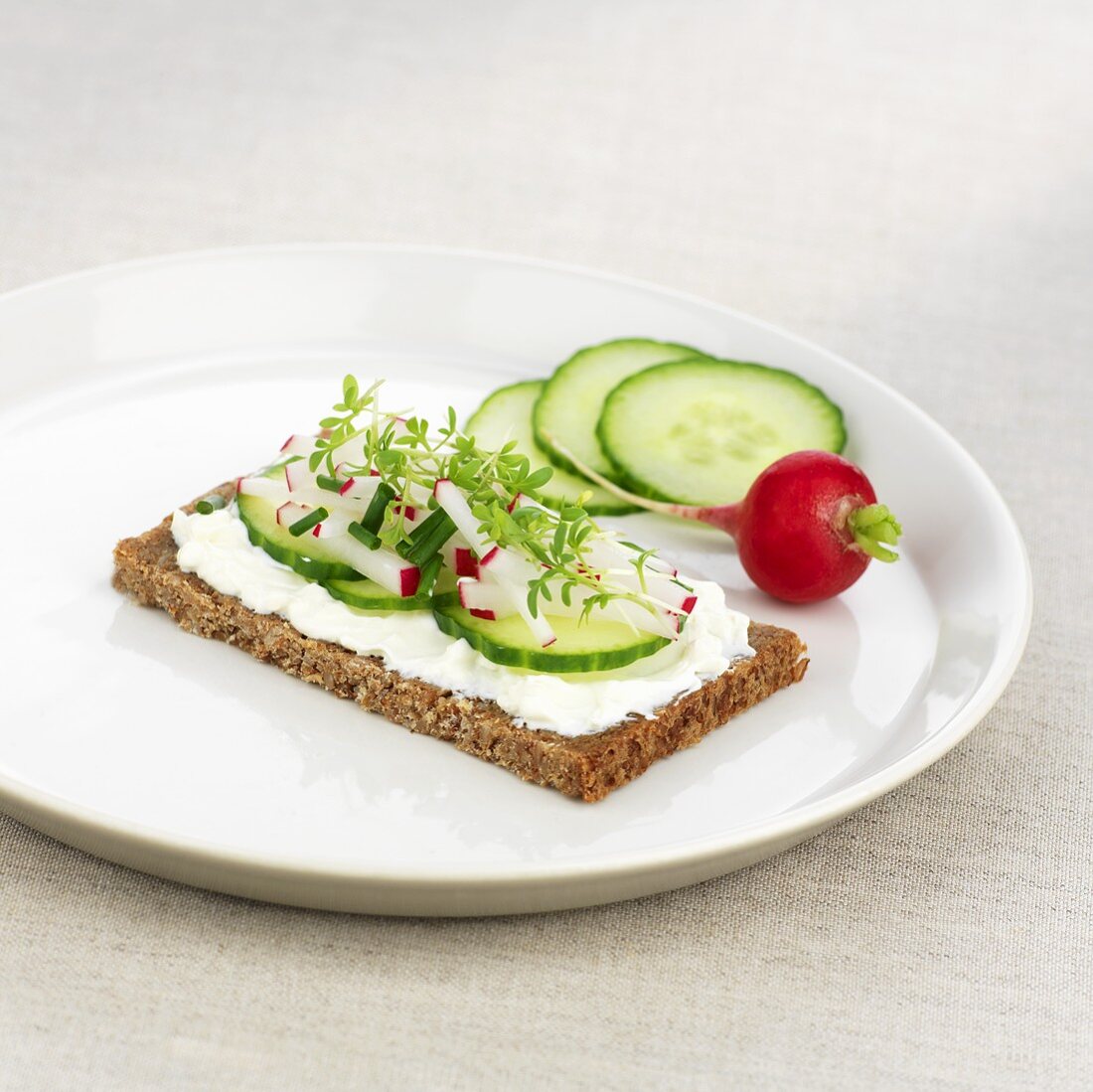 Soft cheese, cucumber, radishes and cress on wholemeal bread