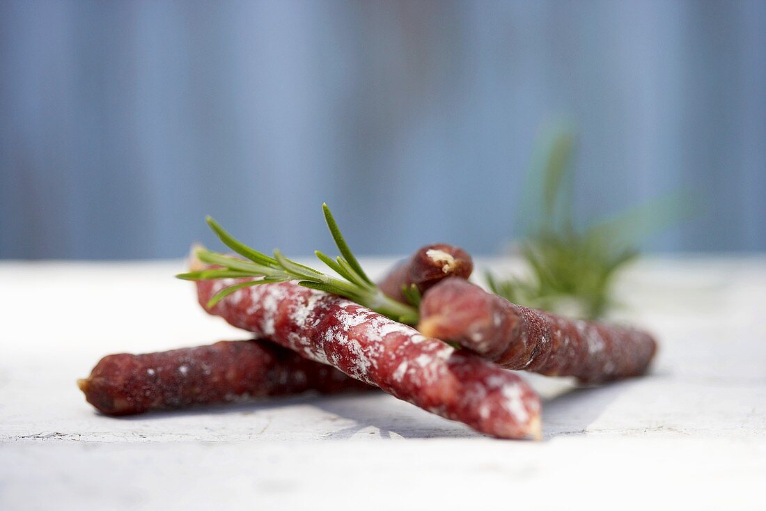 Mini-salami with sprig of rosemary