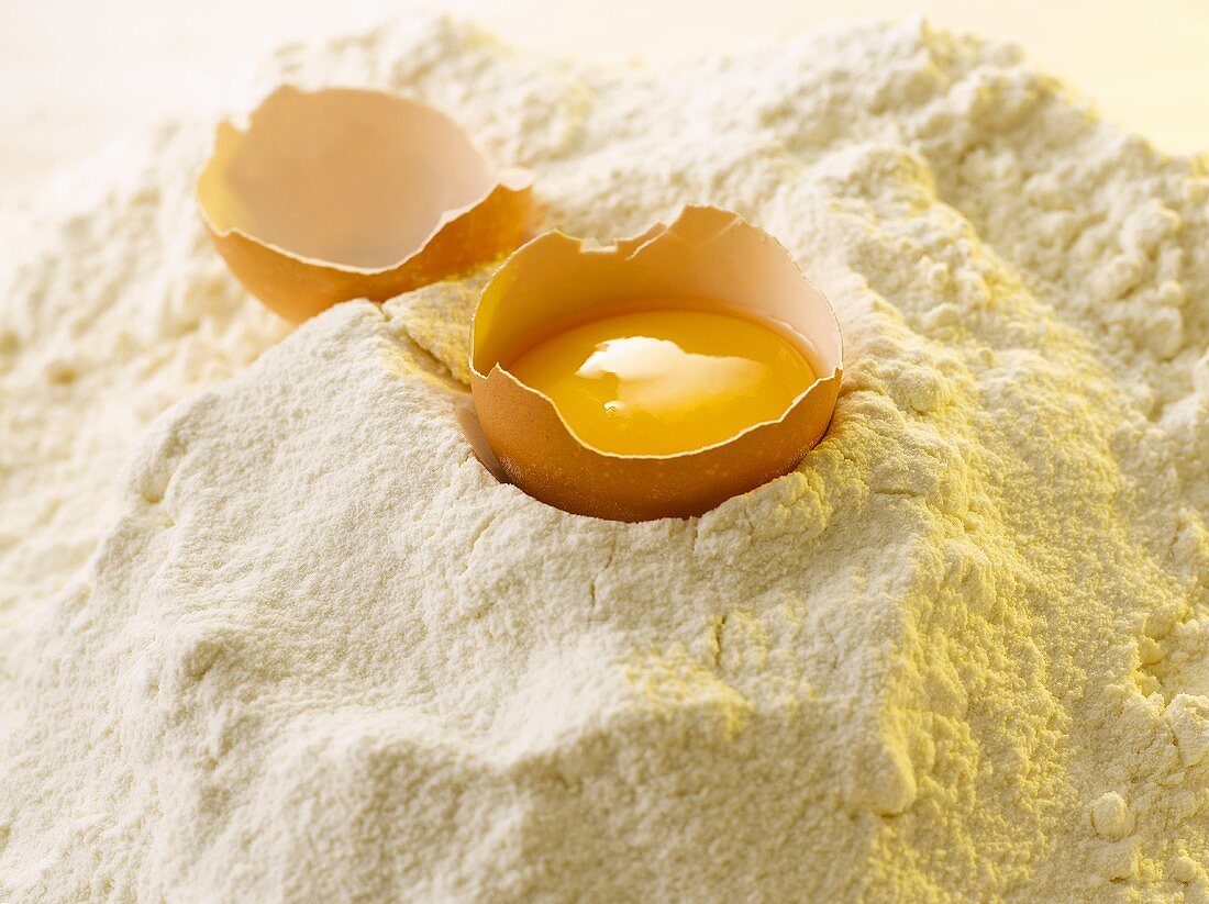 Broken egg on flour