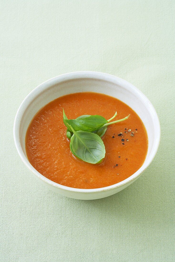 Cold tomato and orange soup with basil