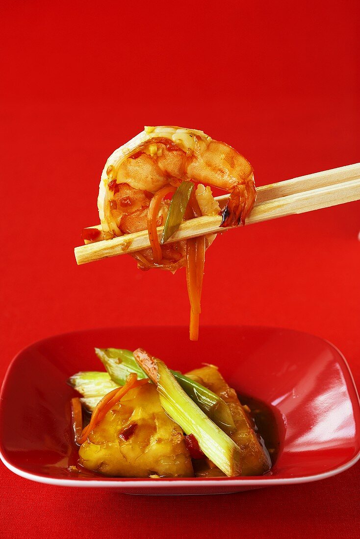 Asian sweet and spicy prawns with chopsticks
