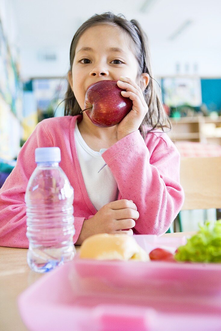 Girl eating an apple at school