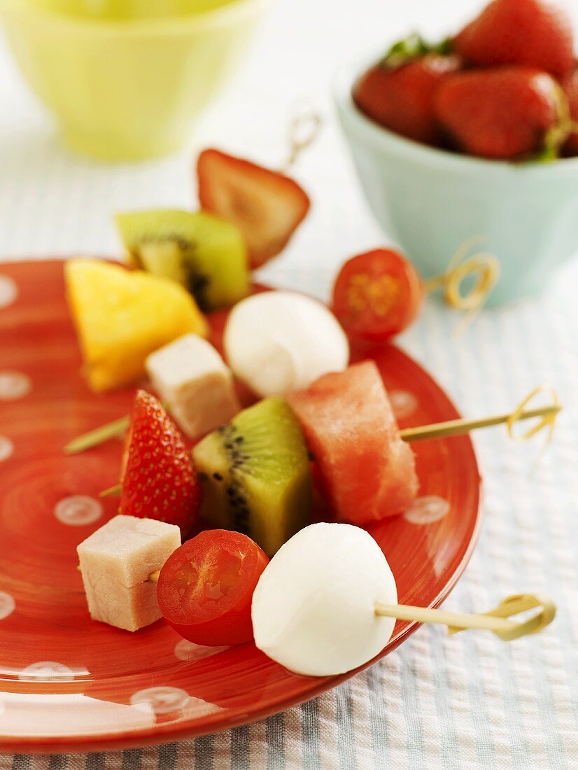 Fruit, tomatoes and mozzarella on skewers