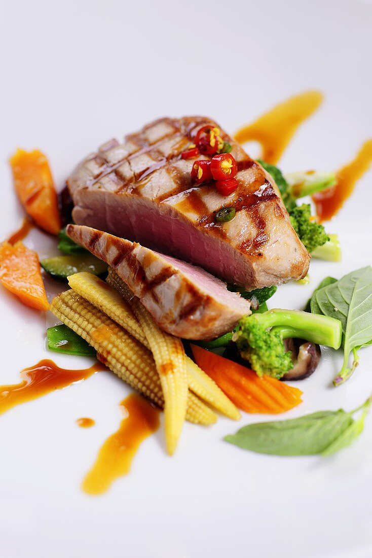 Marinated, grilled tuna on Asian vegetables