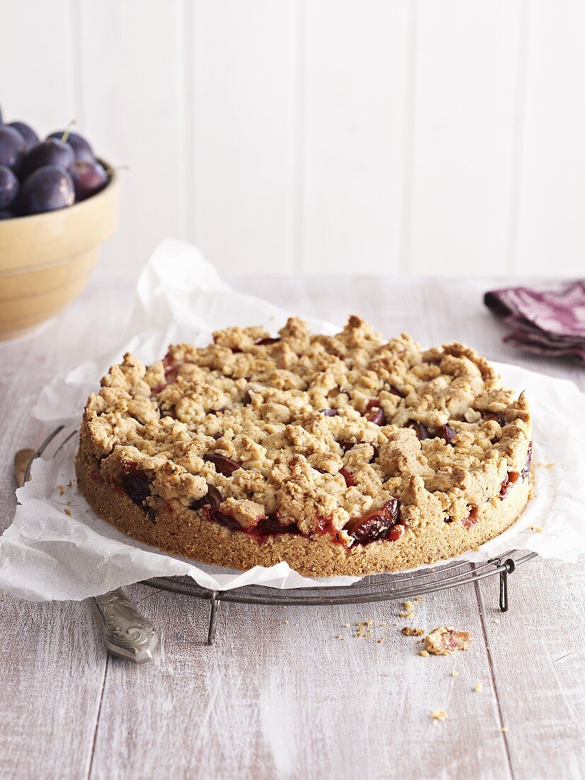 Plum crumble cake on cake rack