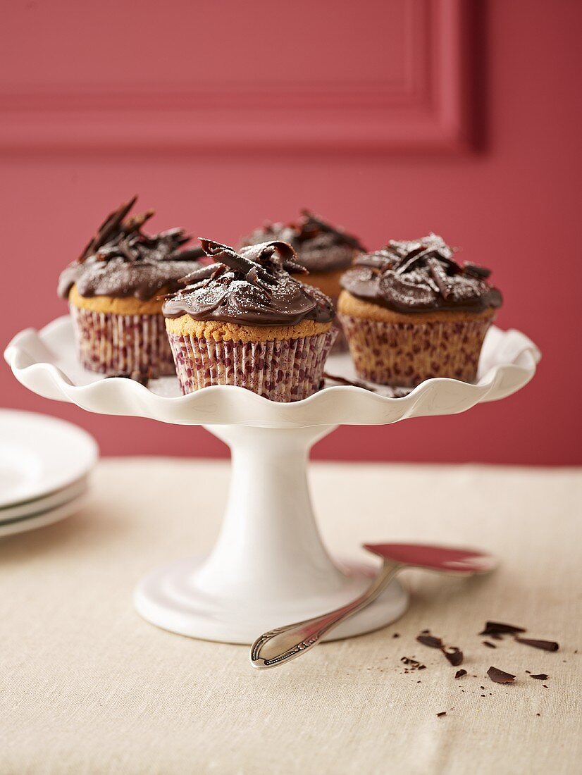 Several chocolate cupcakes on cake stand