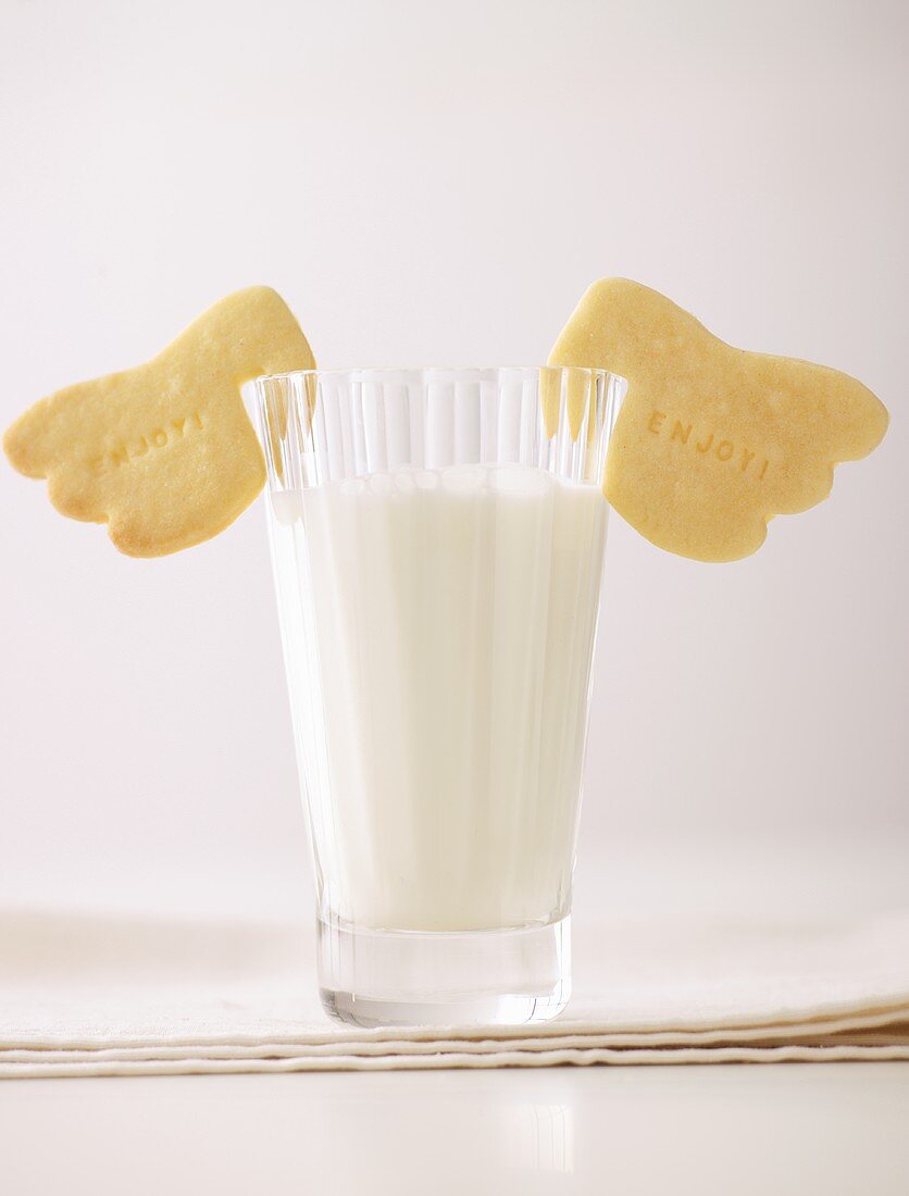Glass of milk and shortbread with the word Enjoy