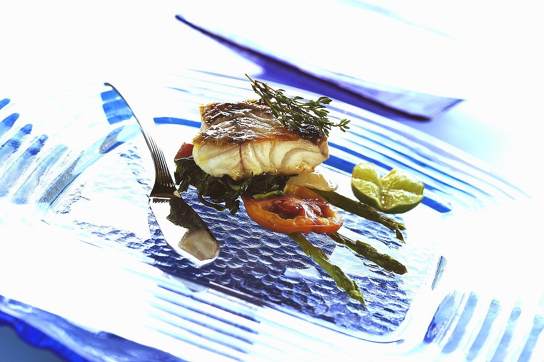 Sea bass with spinach, tomato and asparagus