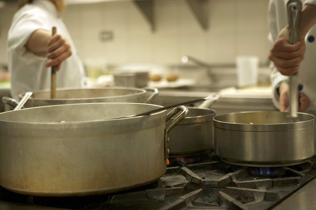 Chefs stirring pans
