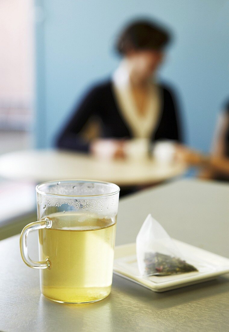 A glass mug of green tea