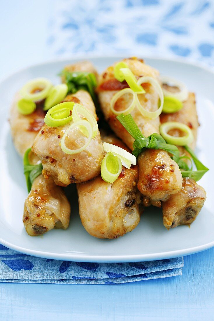Honey mustard drumsticks with spring onions