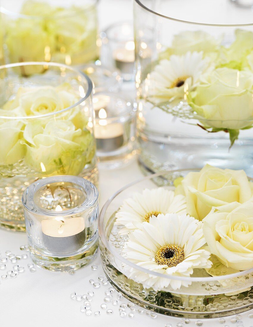 Festive table decoration of white flowers and tealights