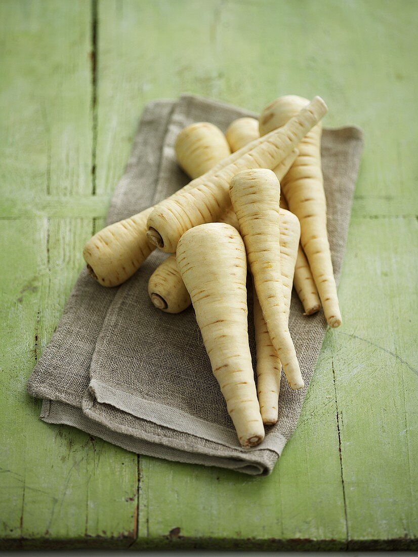 Several parsnips on linen cloth