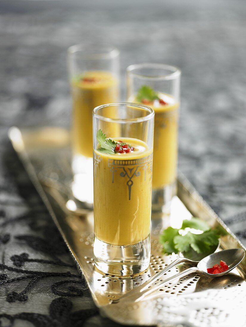 Middle Eastern pumpkin soup in glasses on silver tray
