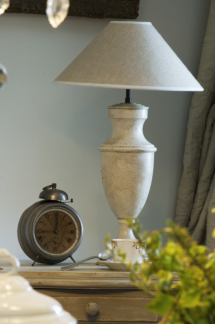 Alarm clock and lamp on a bedside table