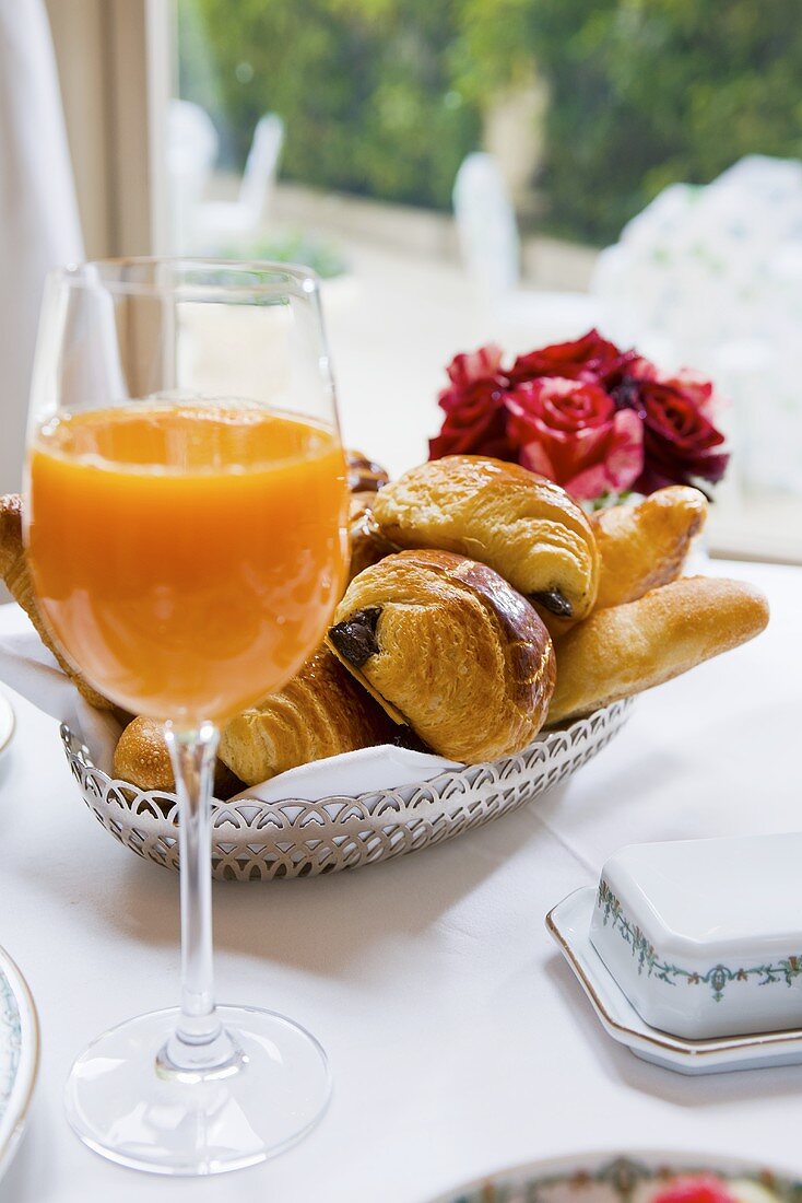 A glass of multivitamin juice and breakfast pastries