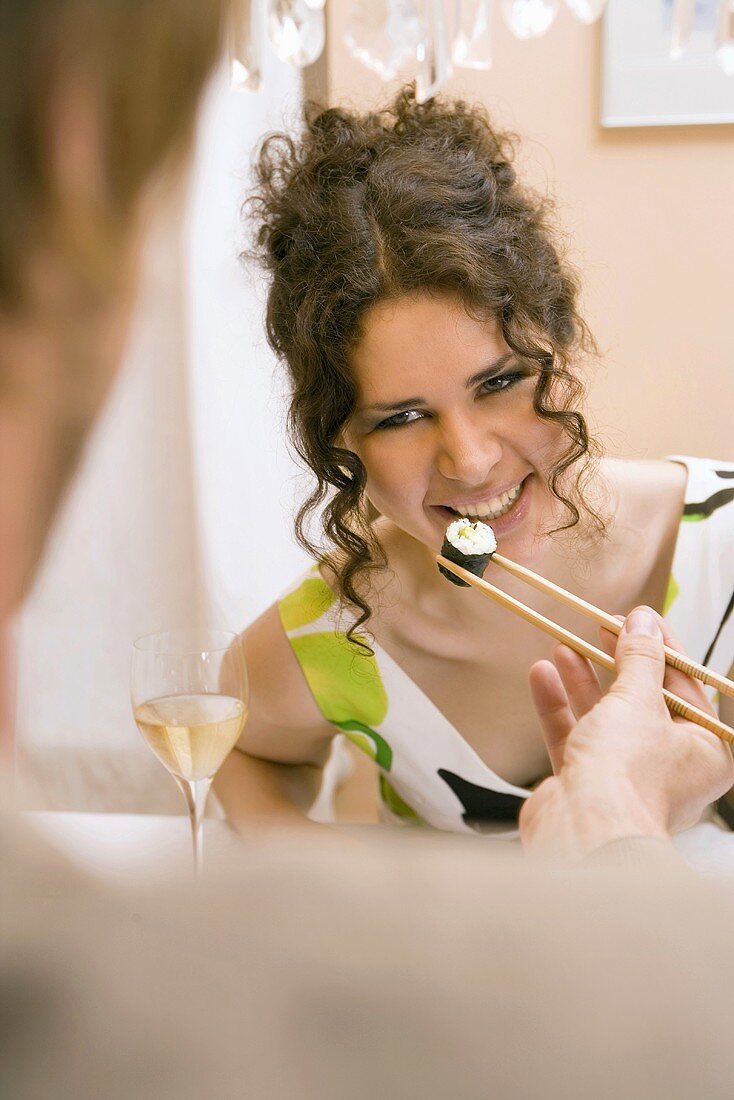 Man Feeding Woman Sushi