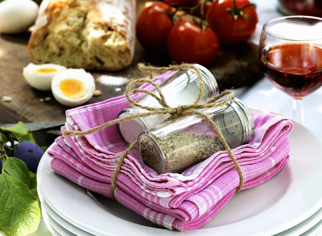 Salt and pepper shakers and napkins, tied together