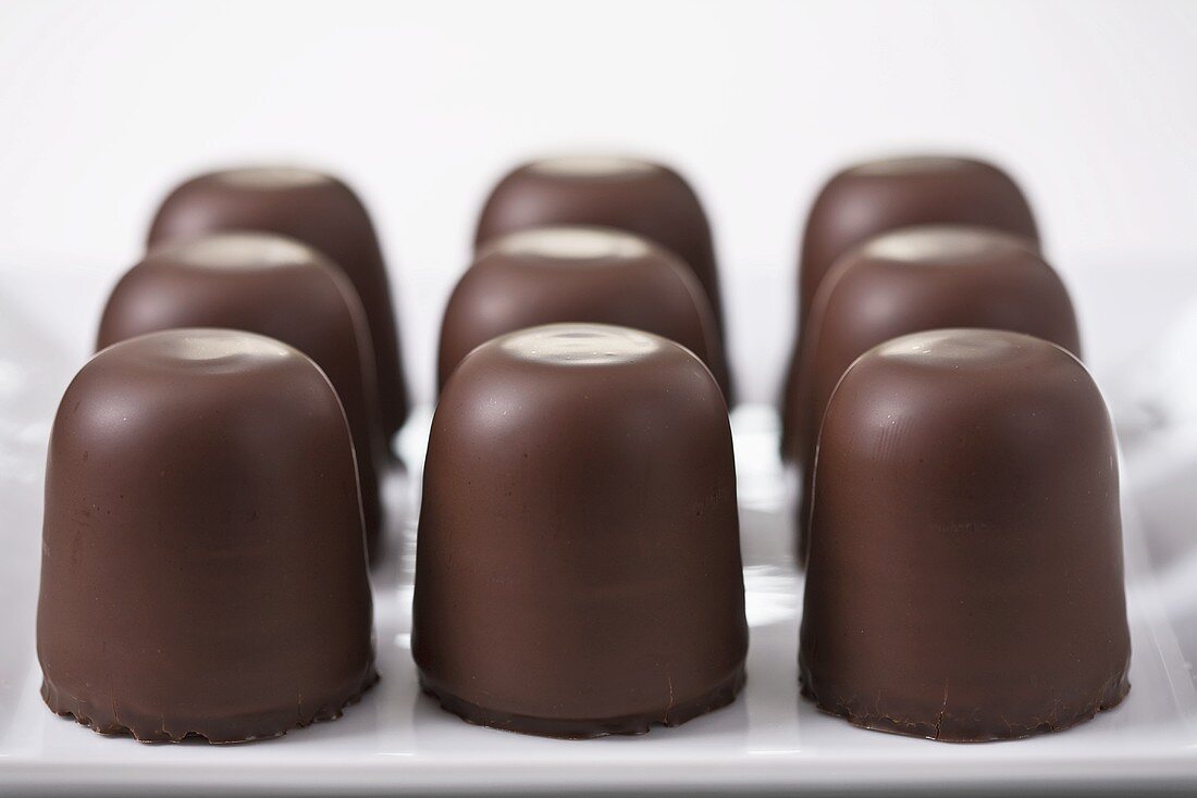 Nine chocolate marshmallows on a platter