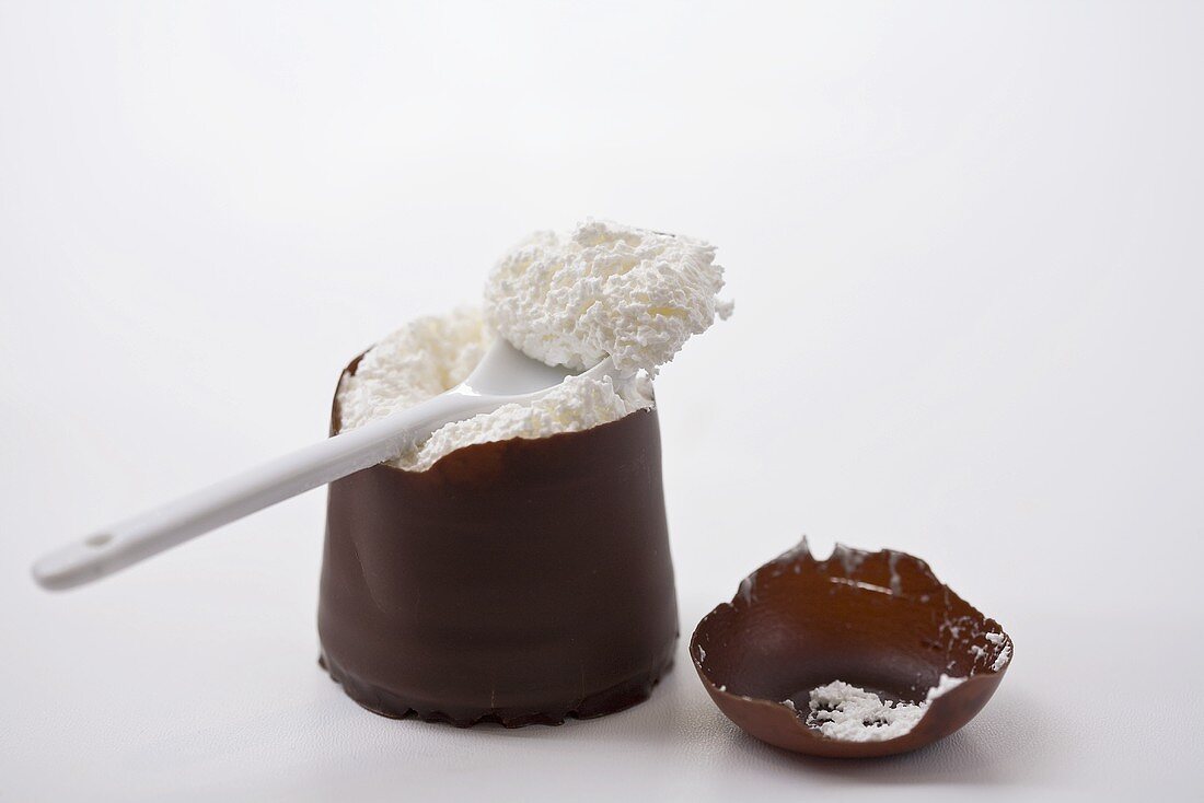 Chocolate marshmallow with broken top and a spoon