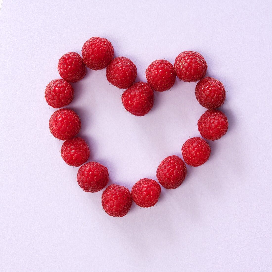 Fresh raspberries forming a heart