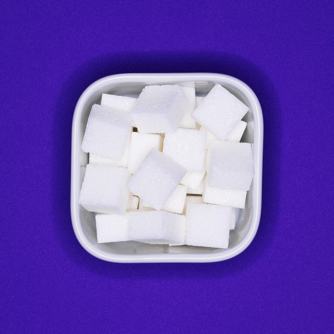 Sugar cubes in a square bowl (overhead view)