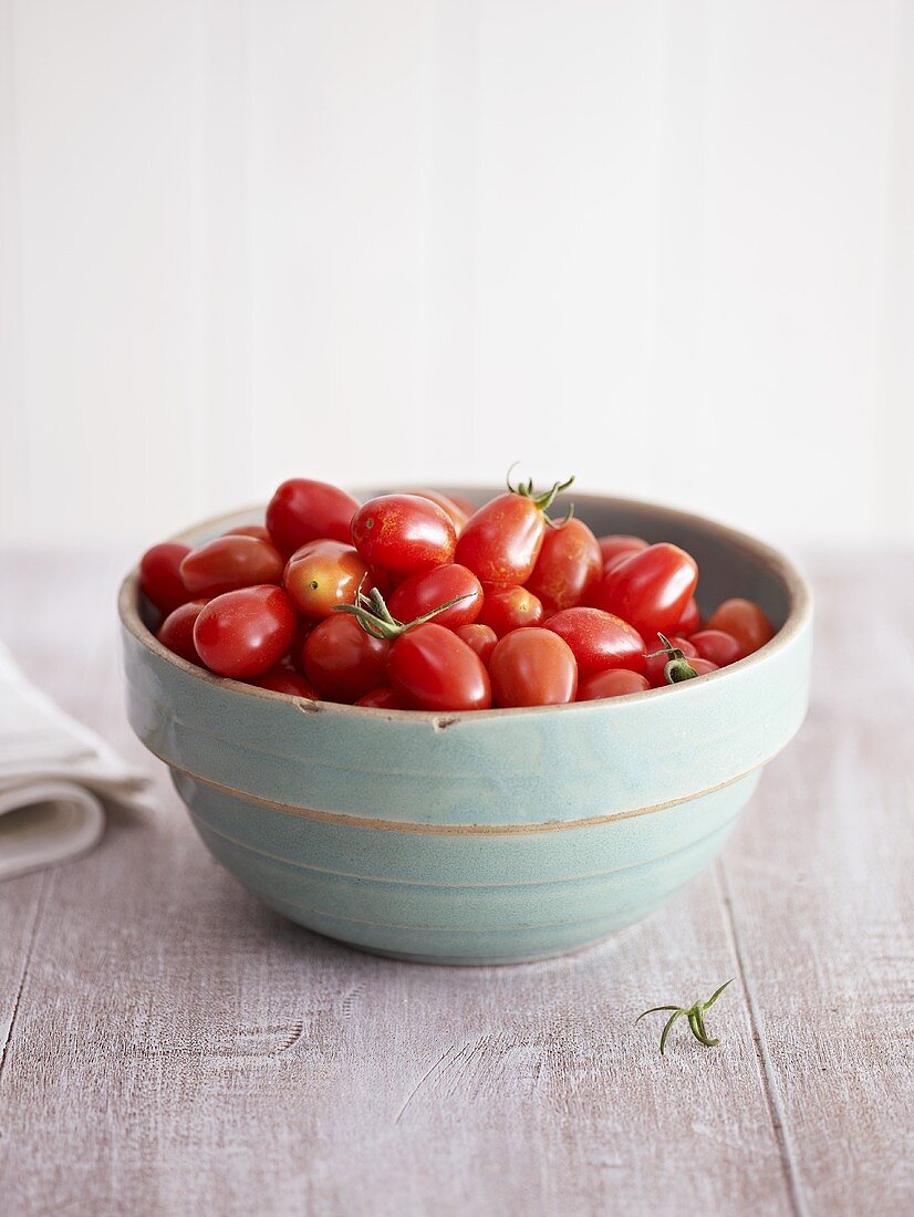 Plum tomatoes in a small bowl