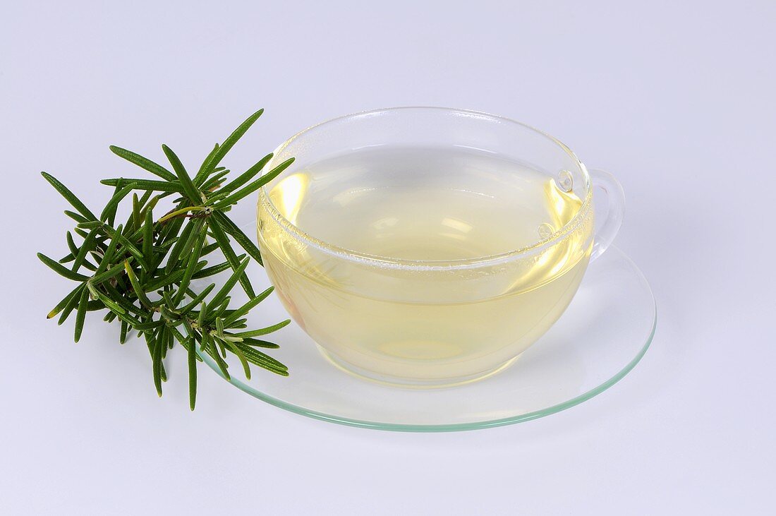 Rosemary tea in glass cup and saucer