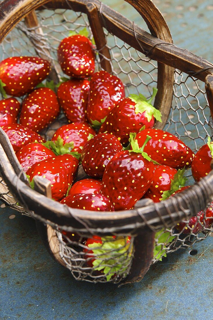 Artificial strawberries in wire basket
