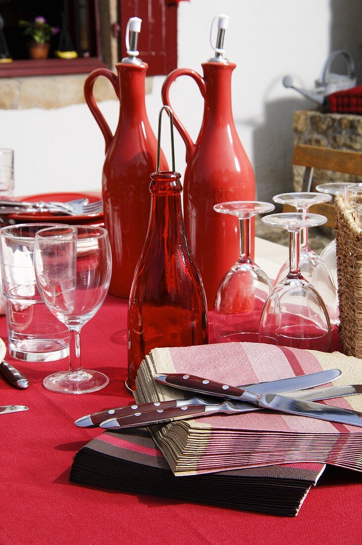 Table laid in red on a terrace