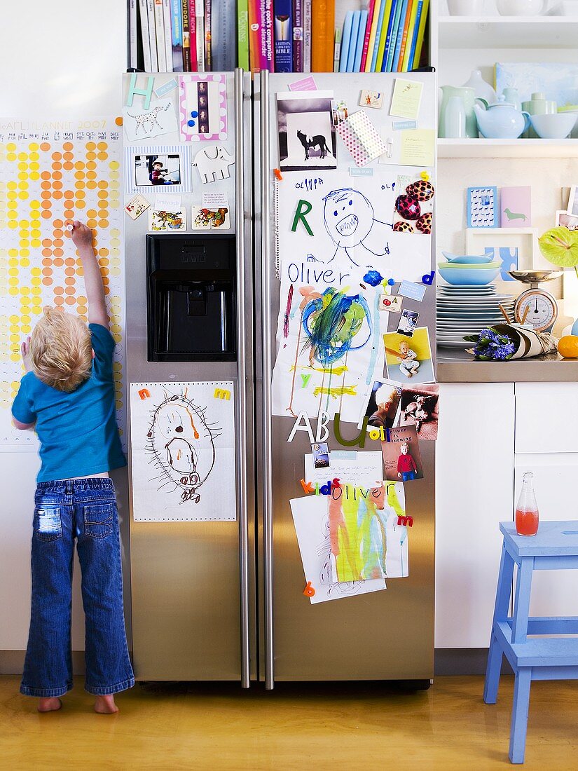 Refrigerator covered in children's pictures