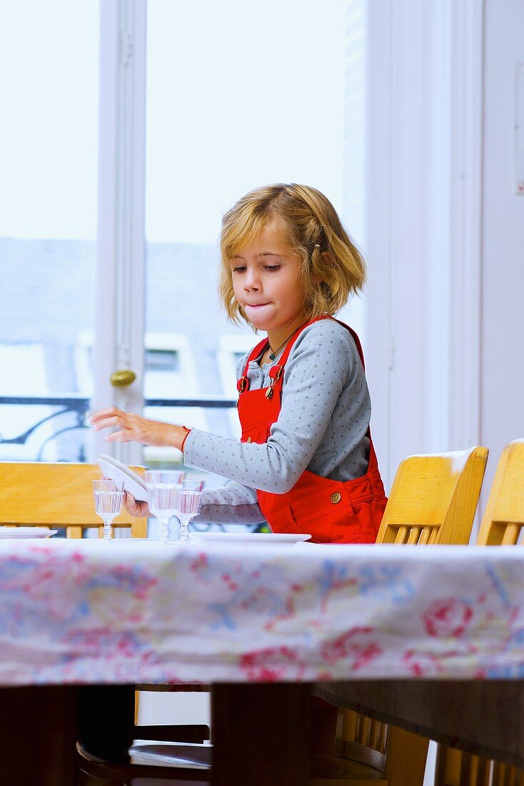 Little girl laying dining table