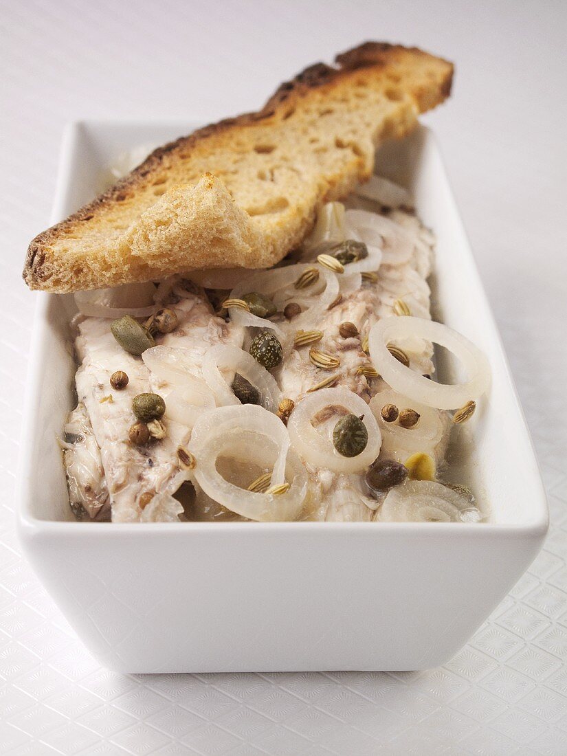Matjes herring fillets with onions, capers and bread
