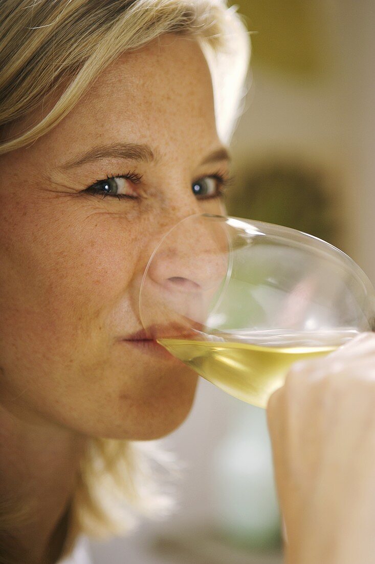 Woman drinking white wine