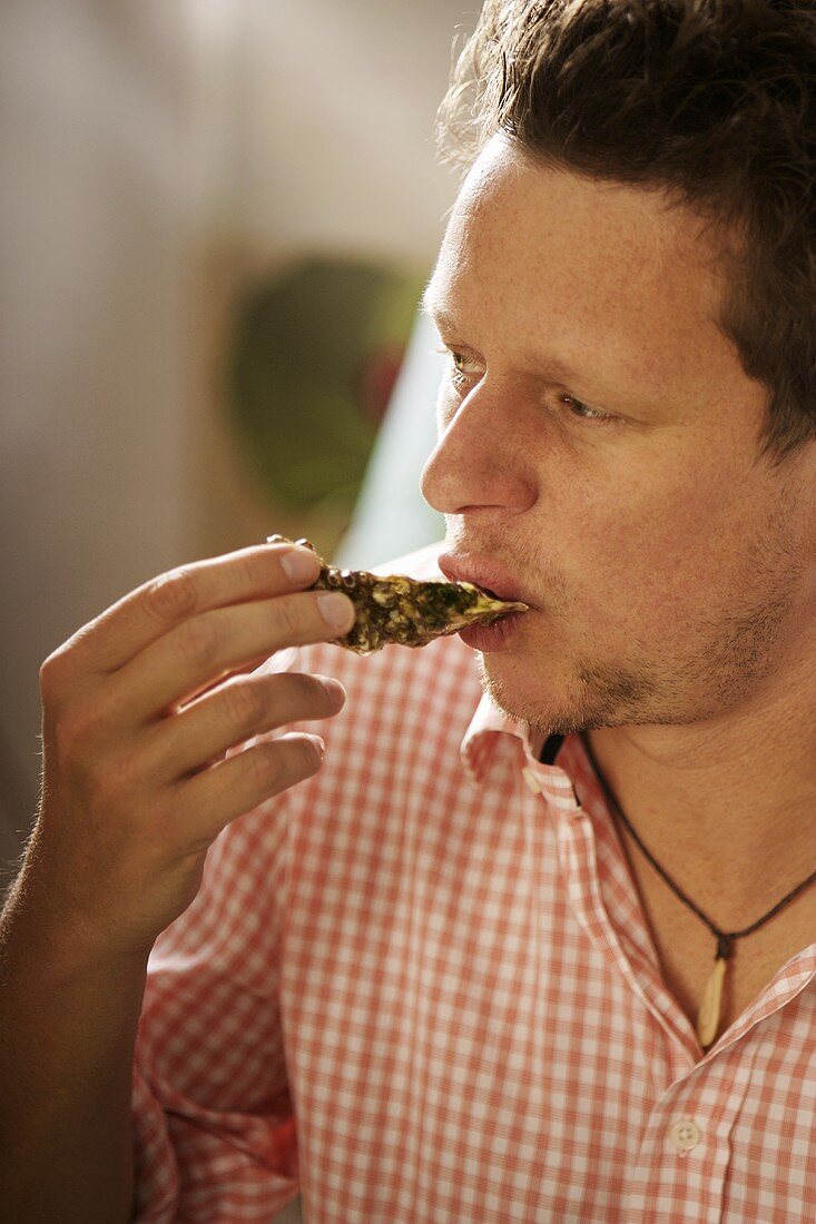 Man eating an oyster