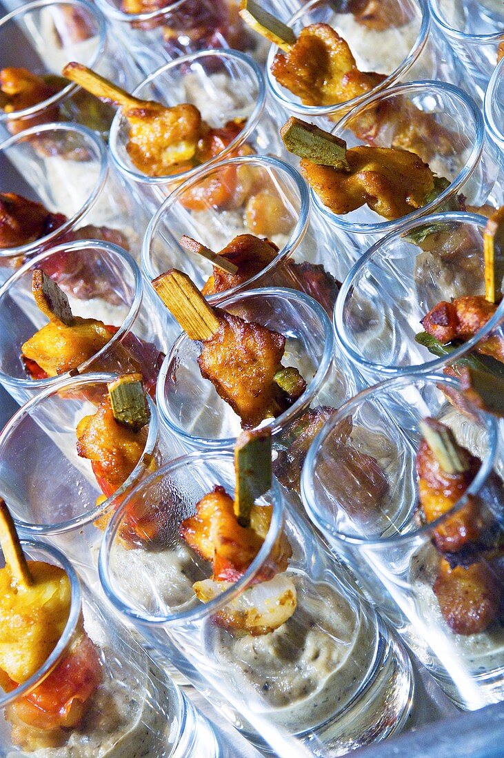 Satay in glasses on a buffet