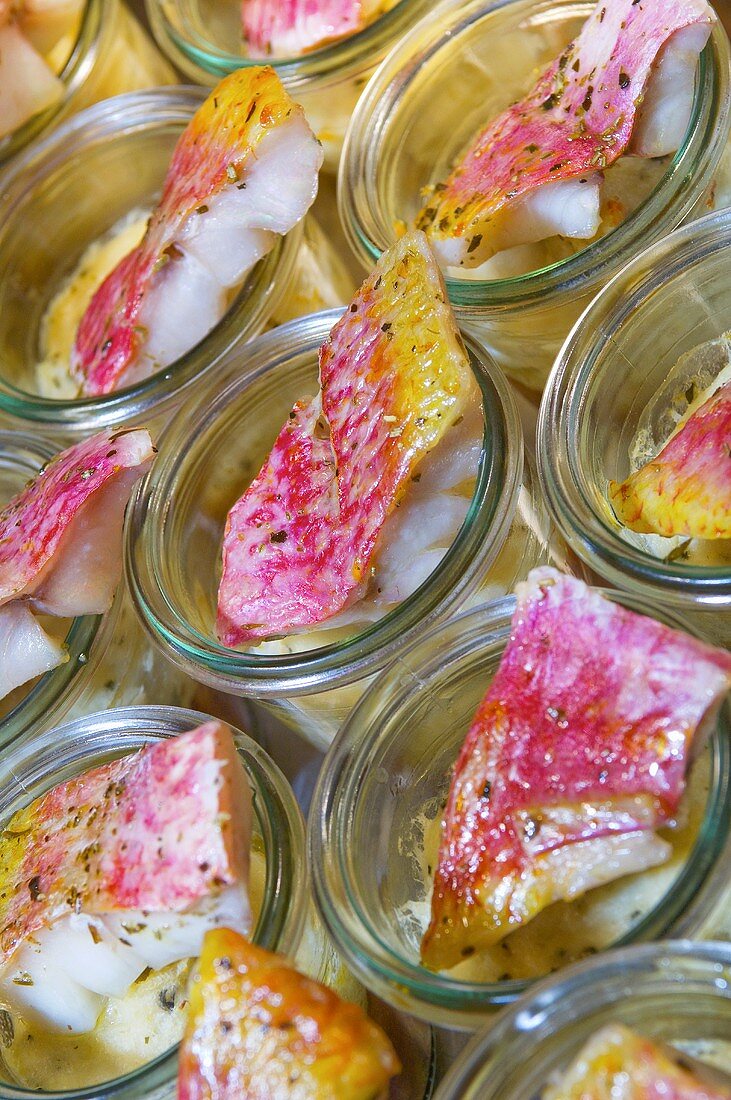 Red mullet fillets in glasses on a buffet